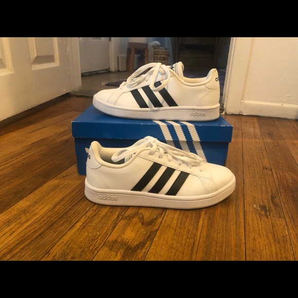 adidas white shoes with black stripes on one side